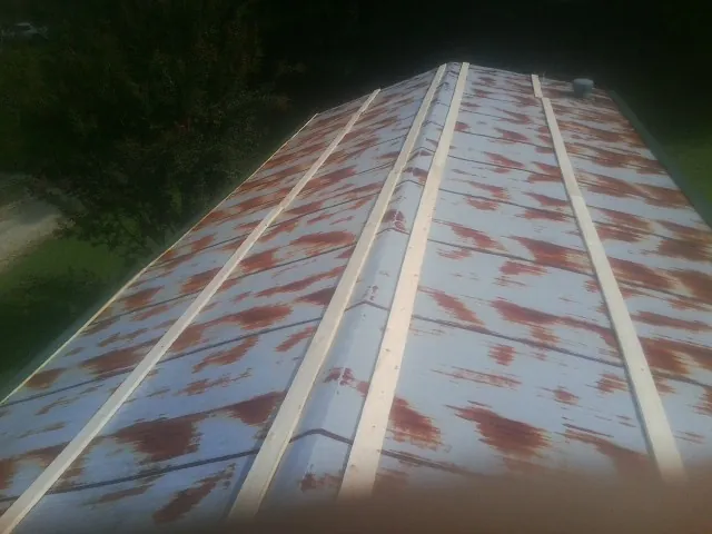 Rusted metal roof panels with new wood purlins before replacement — Storm Damage Roof Repair in Hillburn by Roofing Brothers