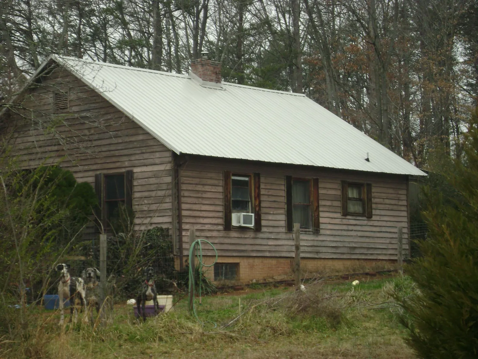 White metal roof on an old wood sided farmhouse, from a Metal Roof Installation job in Hillburn